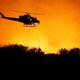 Apocalypse Now: A helicopter flies over a wildfire Thursday, Dec. 7, 2017, in Bonsall, CA. (Image: AP/Gregory Bull)